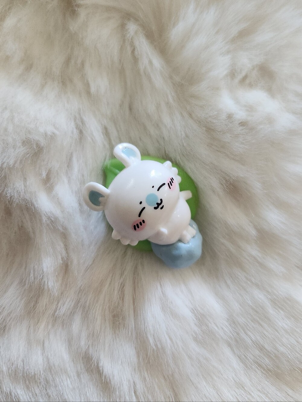 Chiikawa momonga sleeping on a leaf figure